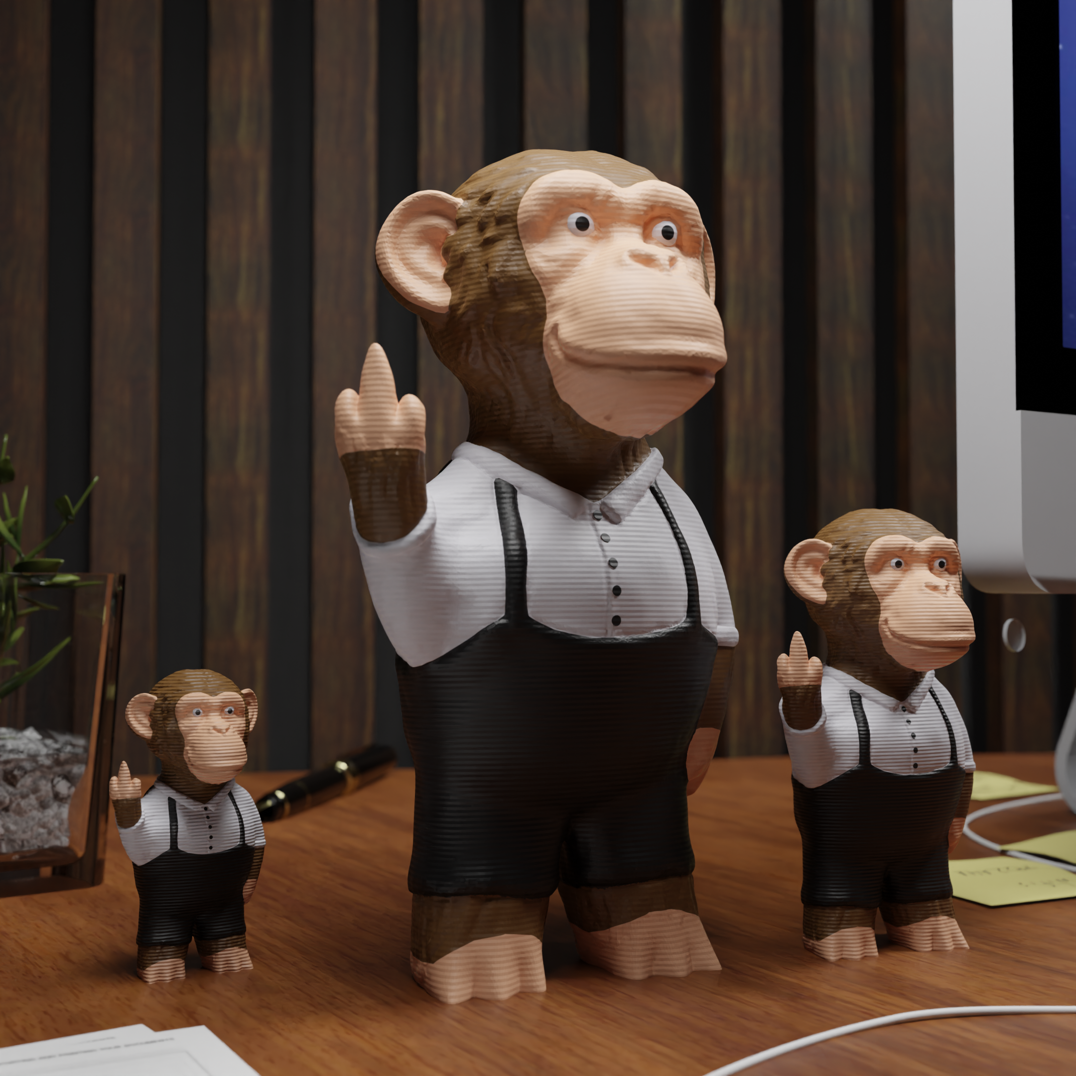 Small ape figurine placed next to a computer, miniature wild animal decoration and funny ape gift for office desk workspace