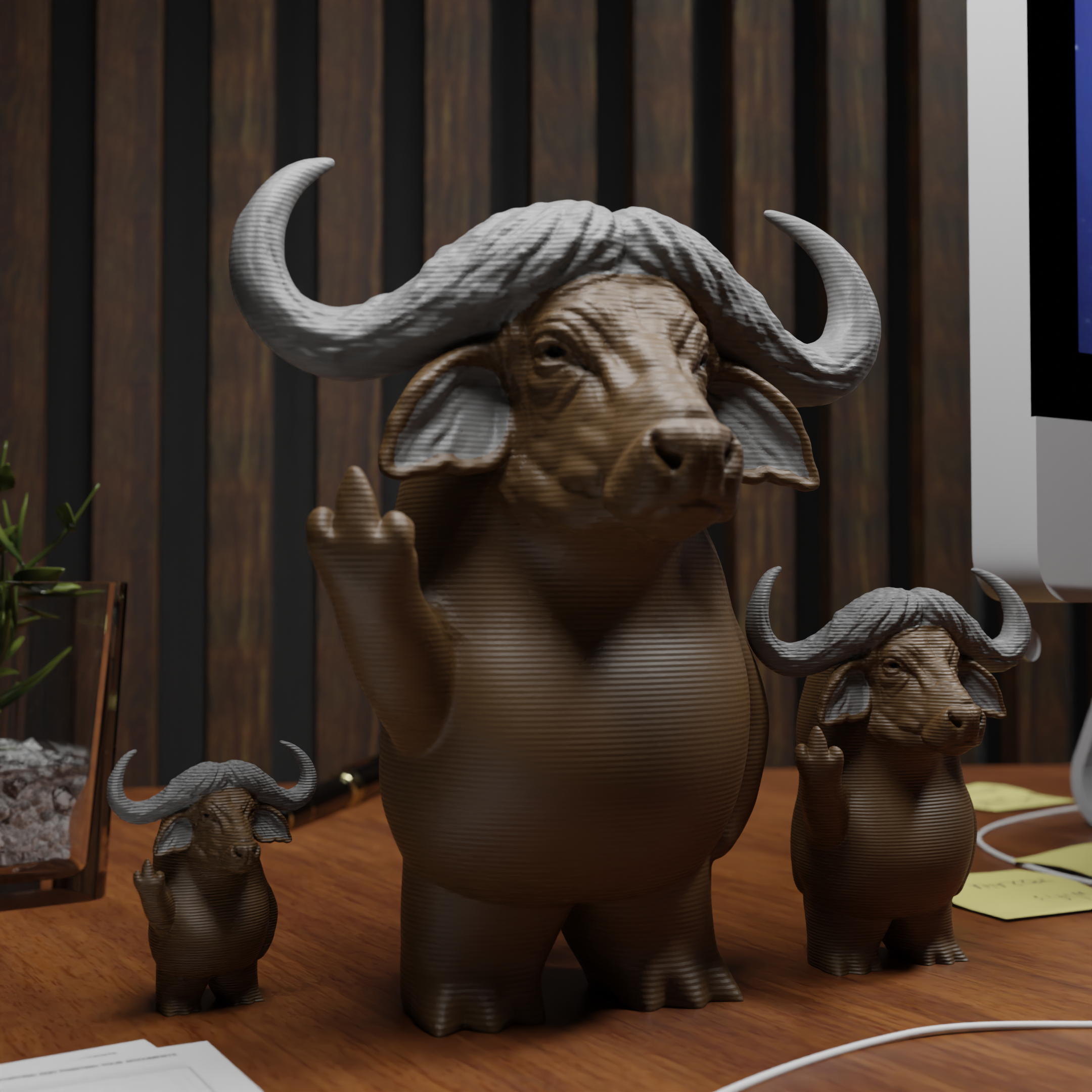 Small buffalo figurine placed next to a computer, miniature wild animal decoration and funny buffalo gift for office desk workspace
