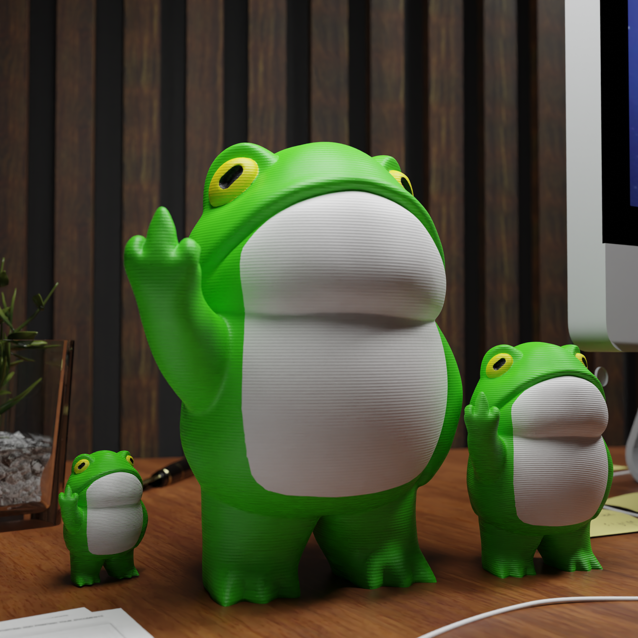 Small frog figurine placed next to a computer, miniature animal decoration and funny frog gift for office desk workspace