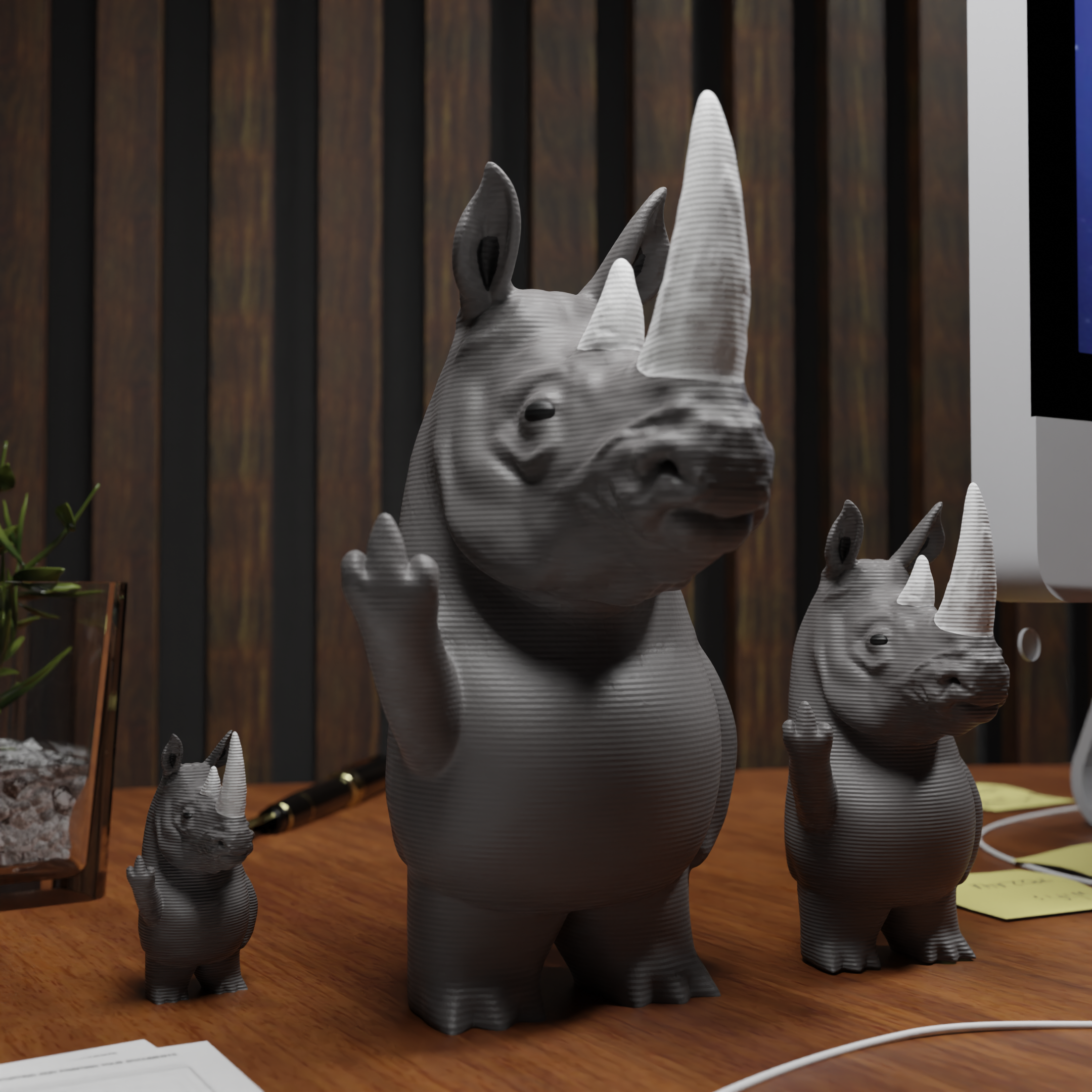 Small rhino figurine placed next to a computer, miniature wild animal decoration and funny rhino gift for office desk workspace